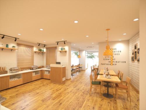 a kitchen and dining room with a table and chairs at Bloom Hotel - ISKCON Rajajinagar in Bangalore