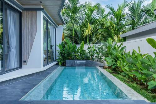 a swimming pool in the backyard of a villa at Stylish 2BR Naiton Aileen Villa w Private Pool in Nai Thon Beach