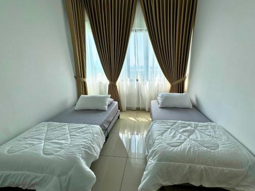 two beds in a room with a window at Almyra cozy condo in Kajang
