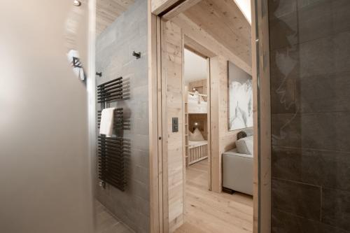 a hallway with a bathroom with a shower and a toilet at Gorfion Familienhotel in Malbun