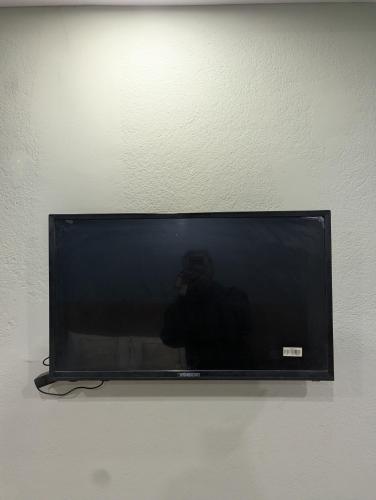 a flat screen tv hanging on a wall at Hotel New Airport in Kathmandu
