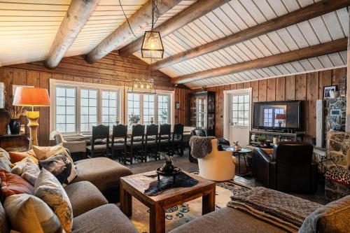 a living room with couches and chairs and a television at TH589- Large ski-in out chalet in Trysilfjell with sauna, hottub in Hovi