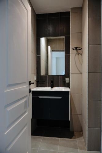 a bathroom with a sink and a mirror at Verinn Apart Hotel in Dilijan