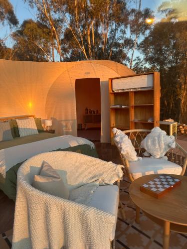 a tent with two beds and a table and chairs at Romantic Stargazing Getaway - Beyond Bubbles in Kanimbla