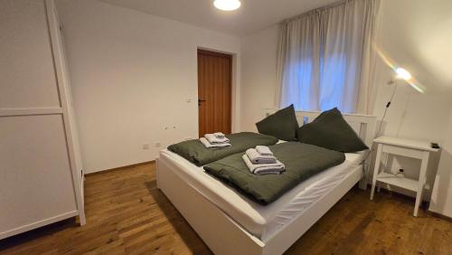 a bedroom with a bed with towels on it at Wirt zSeifriedswörth in Wurmsham