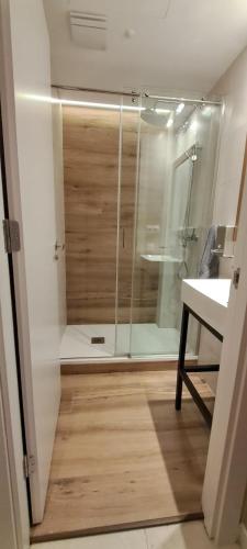 a shower with a glass door in a bathroom at Onefam Sants in Barcelona