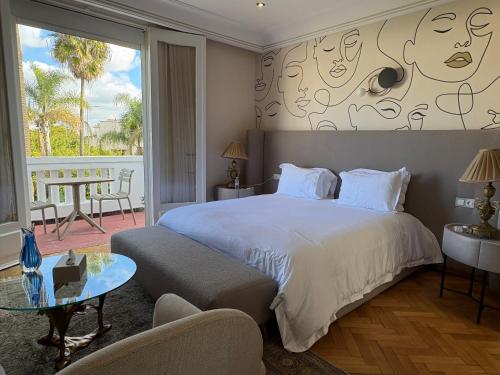 a bedroom with a large bed and a glass table at Palais Elya in Rabat