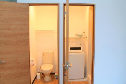 a bathroom with a toilet and a sink at 彩の宿月屋 in Yamanakako