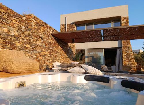 a hot tub in the backyard of a house at Hidden Retreats Kythera in Platia Ammos