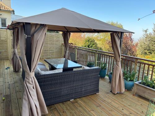 an umbrella on a deck with a table at Redcliffe View - Shared Homestay with Resident Show Dogs in Portishead