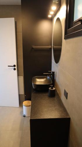 a bathroom with a sink and a mirror on a counter at Amanecer del lago in San Carlos de Bariloche