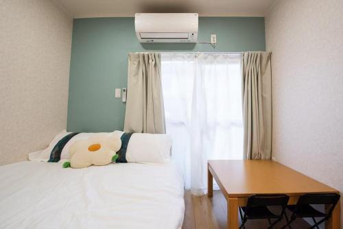 a bedroom with a bed and a desk and a window at Hiregasaki, Nagareyama 2号 CB0439 in Nagareyama