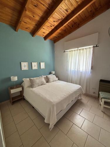 a bedroom with a bed in a room with a window at Casa Marina in Monte Hermoso