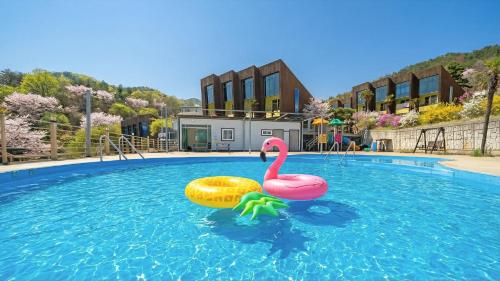a plastic pink flamingo in a swimming pool at Geojedo Pilos Ocean View Pension in Geoje