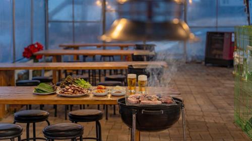 a table with plates of food and beers on it at Ganghwa Herb Pension in Incheon