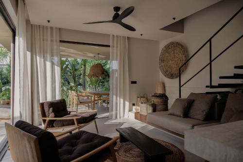 a living room with a couch and a ceiling fan at Terra Mare Villas in Ialysos