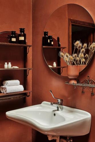 a bathroom with a sink and a mirror at Rifugio Pian di Rocchi in Corniolo