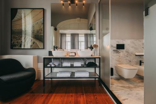 a bathroom with two sinks and a tub at Torel Private Collection in Porto