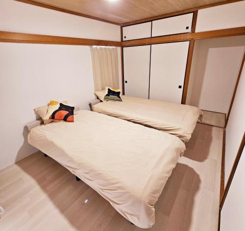 a small bedroom with two beds in it at Itoshima STAY YAMAGA Keya in Itoshima