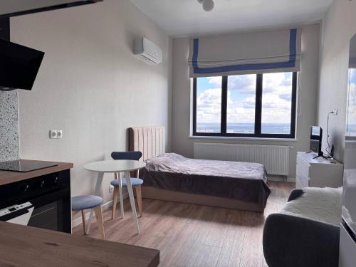 a small room with a bed and a table and a tableablish at comfortable apartment in Vancouver