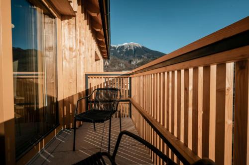 a balcony with a chair and a view of a mountain at Trivrh Outdoor Hotel in Žirovnica