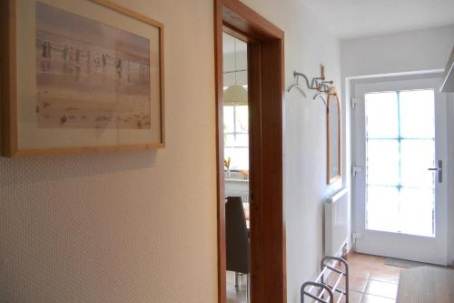 a dining room with a picture on the wall at Rugstieg 8 Whg 2 in Wyk auf Föhr