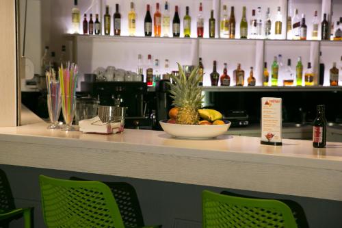 a bar with a bowl of fruit on a counter at Christina Beach Hotel in Kissamos