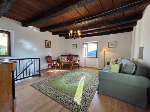 a living room with a couch and a table at Rustic villa with breathtaking views in Oprtalj