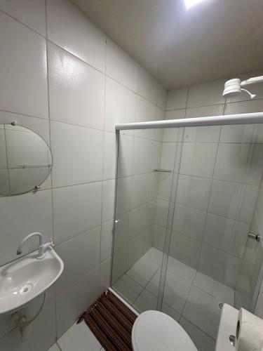 a bathroom with a shower and a toilet and a sink at Pousada Oxente Carioca in João Pessoa