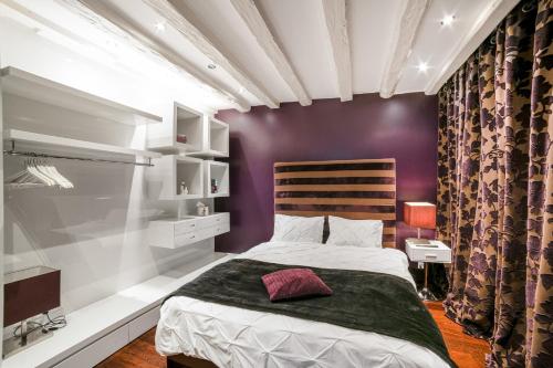 a bedroom with a bed and a purple wall at Fontaine in Geneva