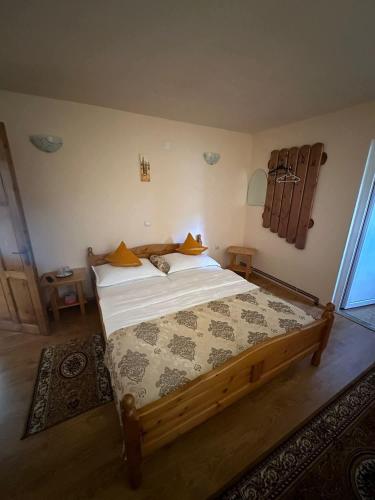 a bedroom with a large wooden bed in a room at Casa cu Muscate in Cîmpeni