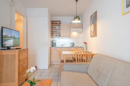 a living room and kitchen with a couch and a table at Fewo 517, Seepark Sellin in Ostseebad Sellin