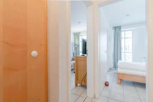 a view of a bedroom with a bed and a mirror at Fewo 517, Seepark Sellin in Ostseebad Sellin
