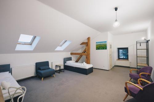 a hospital room with a couch and chairs and a window at Folwark Matecznik - Dworek in Sęzinko