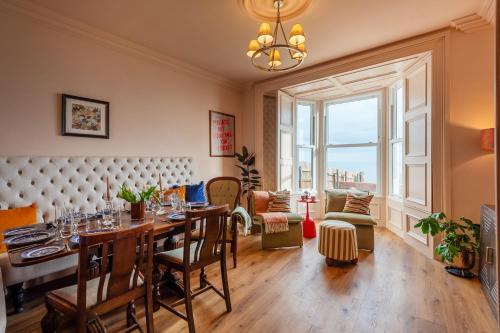 a dining room with a table and a large window at The Beach House Boutique Hotel in Sunderland