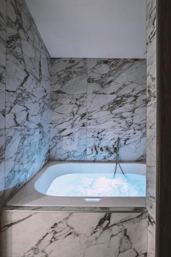 a bathroom with a jacuzzi tub with snow at Suite Cognac - International Palace - Jacuzzi in Vichy