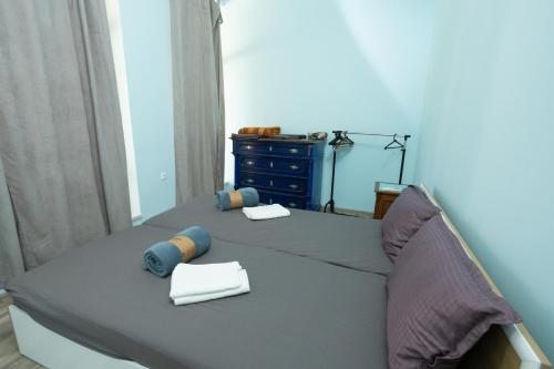 a bed with two pillows and a dresser in a bedroom at Тракия 3А in Shumen