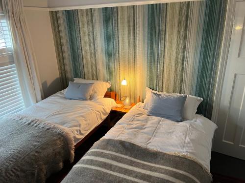 two beds sitting next to each other in a room at The Artist's house in Oxford