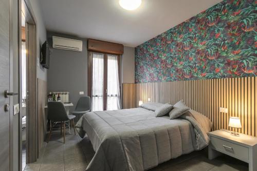 a bedroom with a bed and a large painting on the wall at Residenza Il Fiore in Bergamo