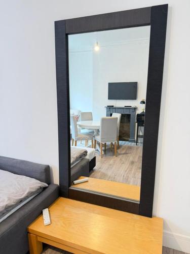 a mirror in a room with a dining room at Rooms in Islington in London
