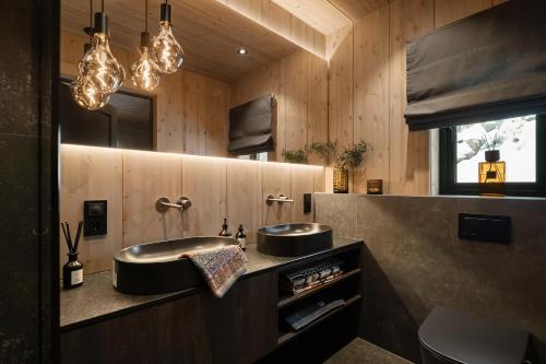 a bathroom with a sink and two mirrors at FJELLRO Private Alpine Lodge Høgevarde in Flå