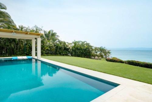 a swimming pool with a view of the ocean at Villa Buho in Punta Mita in Punta Mita