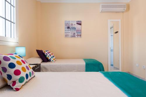 a room with two beds and a couch at Sol y Mar El Salobre in Maspalomas