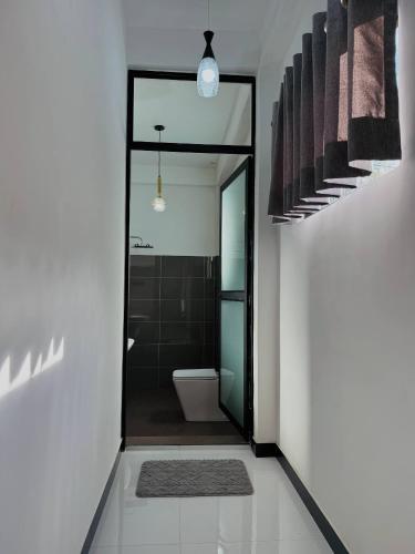 a bathroom with a shower and a toilet and a sink at Climax View Point Inn in Bandarawela