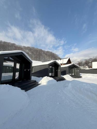 a house covered in snow with a lot of snow at Grey House in Kvasy