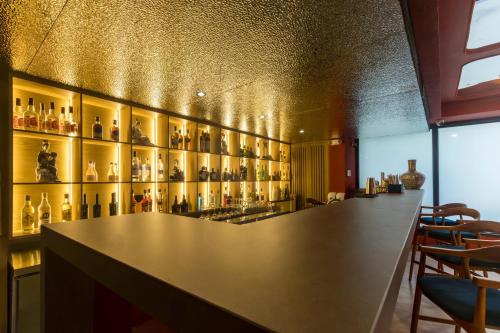 a bar with a lot of bottles on the wall at Berthas Collection By EM Hotels in Cartagena de Indias
