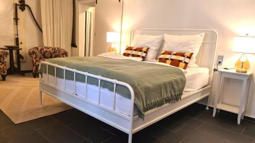 a bedroom with a white bed with two pillows at Mosel-Side De Luxe Suite in Reil