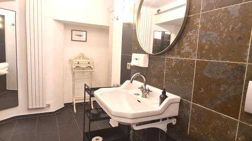 a bathroom with a sink and a mirror at Mosel-Side De Luxe Suite in Reil