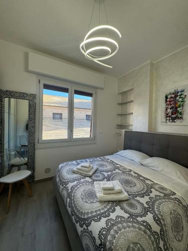 a bedroom with a large bed with towels on it at A casa di Ada in Finale Ligure