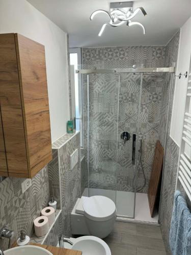 a bathroom with a shower and a toilet and a sink at A casa di Ada in Finale Ligure